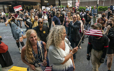 People leaving the venue that hosted the Moms for Liberty meeting argue with demonstrators in Philadelphia, June 30, 2023. (AP Photo/Nathan Howard)