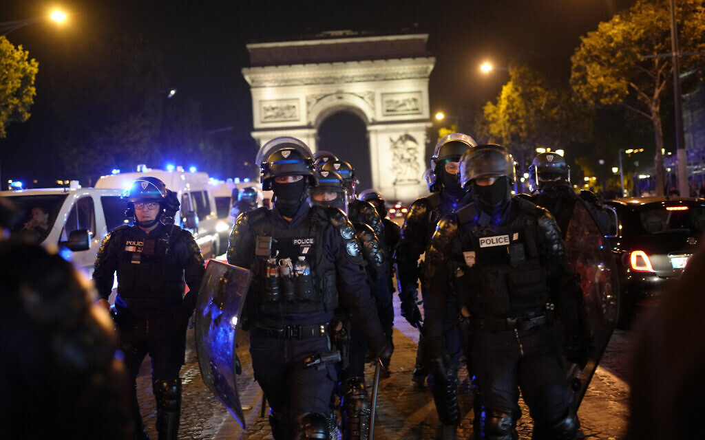 Police officers patrol in front of the Arc de Triomphe on the Champs Elysees in Paris, Saturday, July 1, 2023. (AP/Christophe Ena)