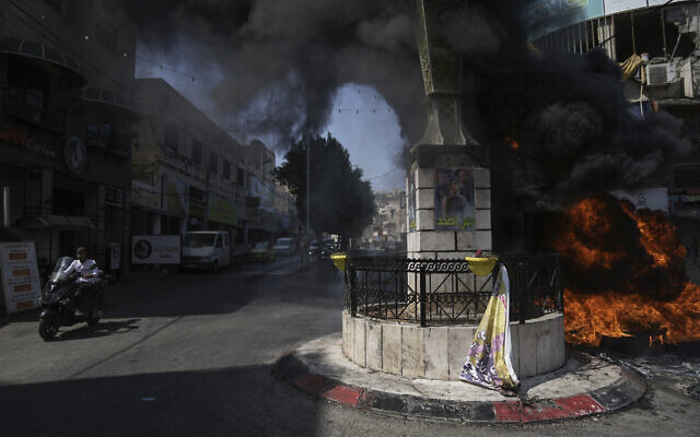 Tires burn during an Israeli military raid in the Jenin refugee camp in the  West Bank, Monday, July 3, 2023.(AP Photo/Nasser Nasser)