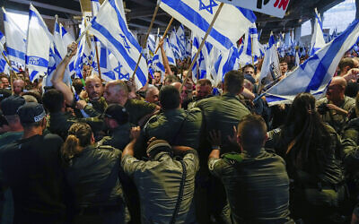 Israeli border police officers work to disperse demonstrators against the judicial overhaul at Ben Gurion Airport, July 3, 2023. (AP Photo/Ohad Zwigenberg)