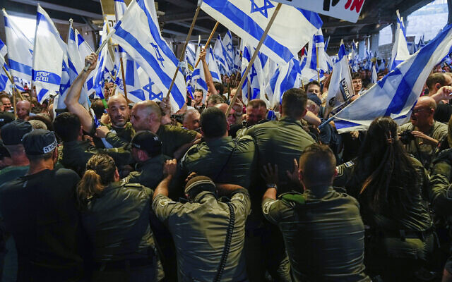 Israeli border police officers work to disperse demonstrators against the judicial overhaul at Ben Gurion Airport, July 3, 2023. (AP Photo/Ohad Zwigenberg)