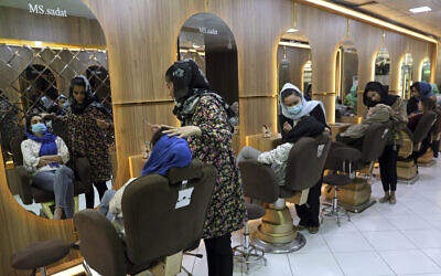 Beauticians put makeup on customers at Ms. Sadat's Beauty Salon in Kabul, Afghanistan, April 25, 2021. (Rahmat Gul/AP)
