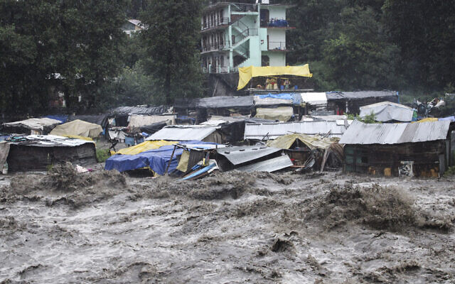 A swollen River Beas following heavy rains in Kullu, Himachal Pradesh, India, July 9, 2023. (Aqil Khan/AP)