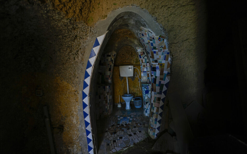 Mosaic decorated toilets sit in a stone-cut chamber in Nissim Kahlon's home chiseled out of the sandstone cliffs overlooking the Mediterranean Sea in Herzliya, June 28, 2023. (AP Photo/Ariel Schalit)