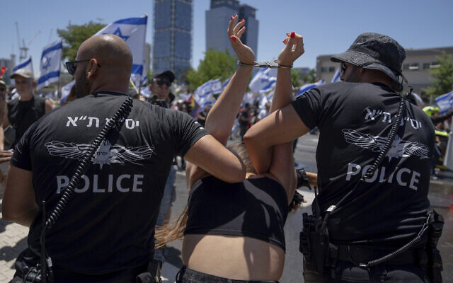 Police detain a demonstrator against the judicial overhaul, in Tel Aviv on July 11, 2023 (AP Photo/Oded Balilty)