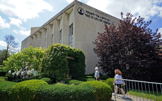 People walk outside the dormant landmark Tree of Life synagogue in Pittsburgh's Squirrel Hill neighborhood on Thursday, July 13, 2023. (AP/Gene J. Puskar)