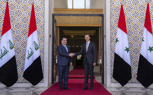 Syrian President Bashar Assad (right) welcomes Iraq's Prime Minister Mohammed Shia al-Sudani during a welcome ceremony in Damascus, Syria, July 16, 2023. (SANA via AP)