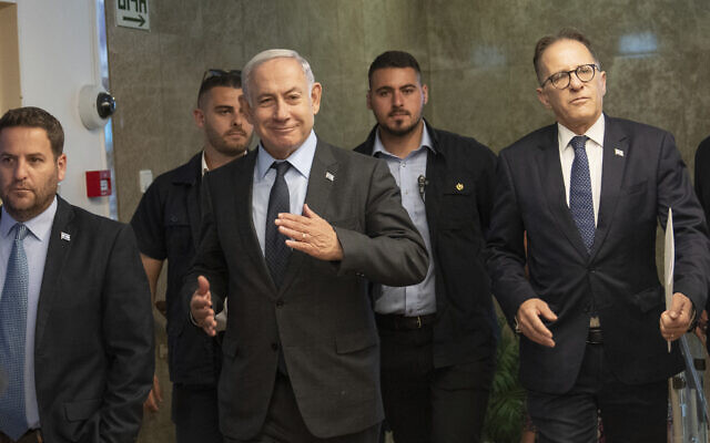 Prime Minister Benjamin Netanyahu, center, arrives to chair a cabinet meeting at his office in Jerusalem, July 17, 2023. (AP Photo/Ohad Zwigenberg, Pool)