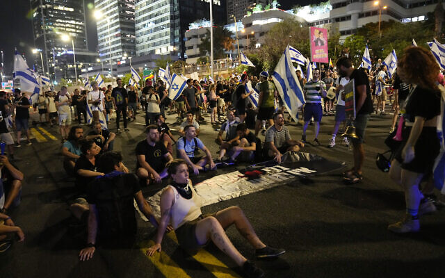 Israelis block the Ayalon Highway to protest against plans by Prime Minister Benjamin Netanyahu's government to overhaul the judicial system, in Tel Aviv, Friday, July 21, 2023. (AP Photo/Ohad Zwigenberg)
