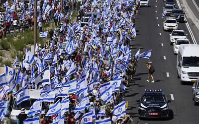 Thousands of Israelis march along a highway towards Jerusalem in protest of plans by Prime Minister Benjamin Netanyahu's government to overhaul the judicial system, near Abu Gosh, Israel, July 22, 2023 (AP Photo/Ohad Zwigenberg)