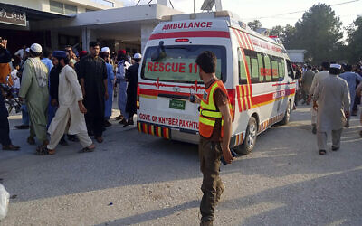 In this photo provided by Rescue 1122 Head Quarters, an ambulance carries injured people after a bomb explosion in the Bajur district of Khyber Pakhtunkhwa, Pakistan, Sunday, July 30, 2023. A powerful bomb ripped through a rally by supporters of a hard-line cleric and political leader in the country’s northwestern Bajur district that borders Afghanistan on Sunday. (Rescue 1122 Head Quarters via AP)