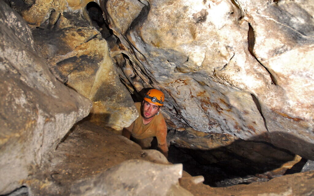 Boaz Langford entering a deep crevice in the Teomim Cave near Beit Shemesh, where researchers have been exploring since 2009. (courtesy Boaz Zissu)