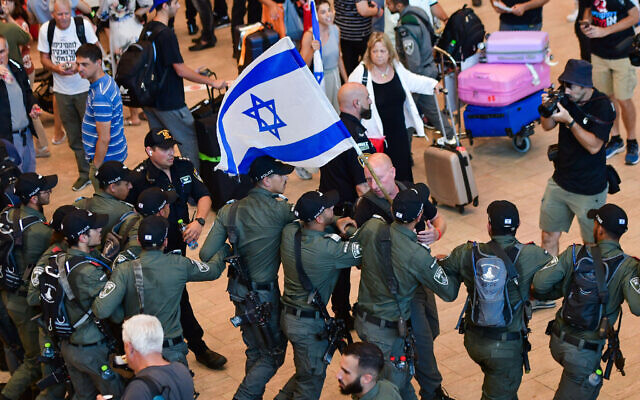 Police evacuate protesters from the arrival hall during a protest against the Israeli government's planned judicial overhaul, at the Ben Gurion Airport near Tel Aviv, July 3, 2023 (Avshalom Sassoni/Flash90)
