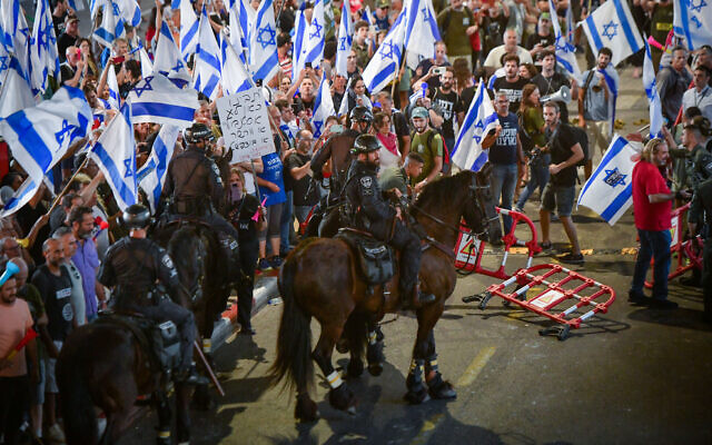 Mounted police officers try to disperse protesters against the government's planned judicial overhaul, at Ben Gurion Airport near Tel Aviv, July 3, 2023. (Avshalom Sassoni/Flash90)