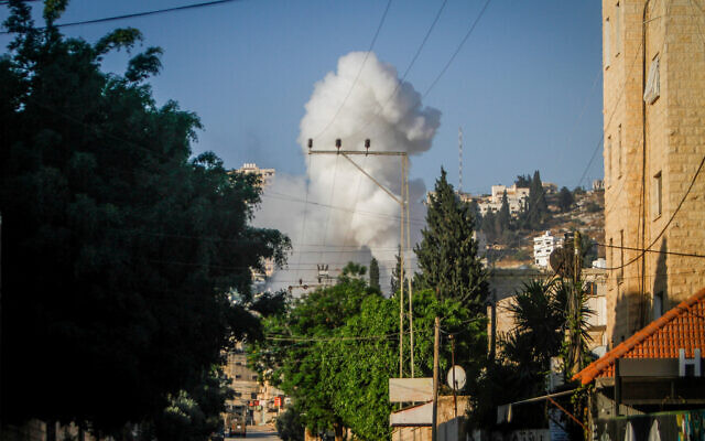Smoke rises as Israel begins an operation in the West Bank city of Jenin, July 3, 2023 (Nasser Ishtayeh/Flash90)