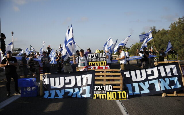 Demonstrators against the judicial overhaul block a main road at the entrance to Haifa, July 11, 2023. (Shir Torem/Flash90)