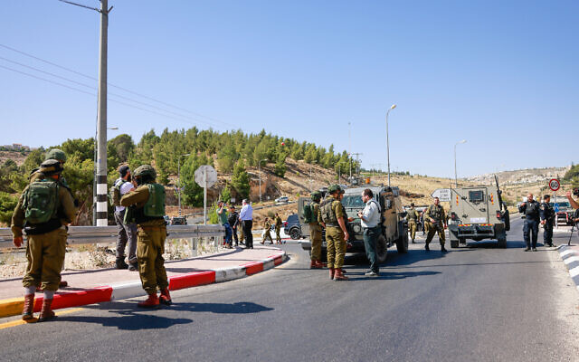 Israeli forces at the scene of a terrorist shooting attack, near the West Bank settlement of Tekoa, July 16, 2023. (Chaim Goldberg/Flash90)