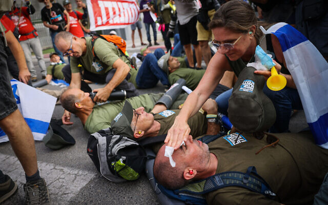 Israelis block the entrance to IDF headquarters in Tel Aviv as they protest the government's judicial overhaul, July 18, 2023. (Chaim Goldberg/Flash90)