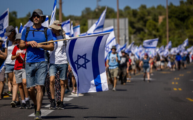 Anti-overhaul protesters march on Route 1 near Abu Ghosh, as part of the protests against the government's judicial overhaul, on July 22, 2023 (Yonatan Sindel/Flash90)