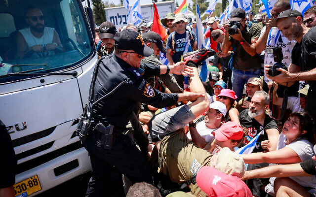 Anti-overhaul activists block a road during a protest against the government's judicial overhaul, near the Knesset in Jerusalem, on July 24, 2023. (Chaim Goldberg/Flash90)