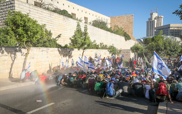 Anti-overhaul activists block a raod during a protest against the government's judicial overhaul, near the Knesset, in Jerusalem, on July 24, 2023. (Jamal Awad/Flash90)
