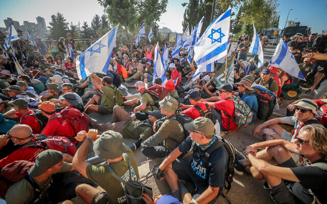 Anti-overhaul activists block a road during a protest against the government's judicial overhaul, near the Knesset, the Israeli parliament in Jerusalem, on July 24, 2023. (Jamal Awad/Flash90)