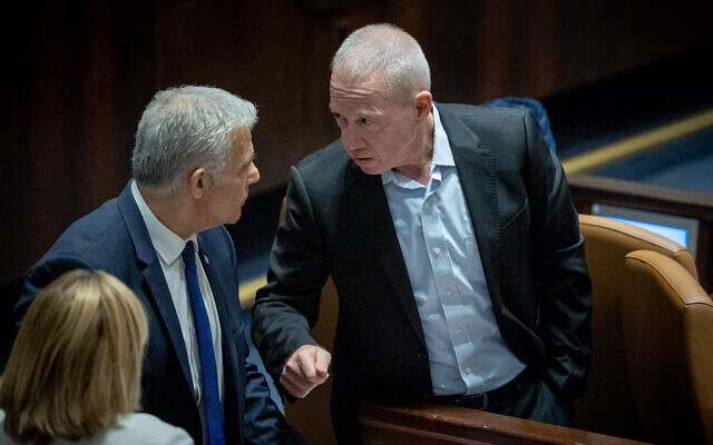 Opposition leader Yair Lapid (left) and Defense Minister Yoav Gallant attend a vote on the 'reasonableness' bill at the Knesset, in Jerusalem, July 24, 2023. (Yonatan Sindel/Flash90)