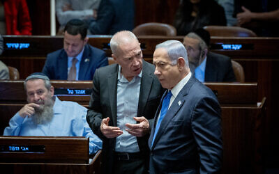 Prime Minister Benjamin Netanyahu (right) speaks with Defense Minister Yoav Gallant during a vote on the so-called reasonableness bill at the Knesset, July 24, 2023. (Yonatan Sindel/Flash90)