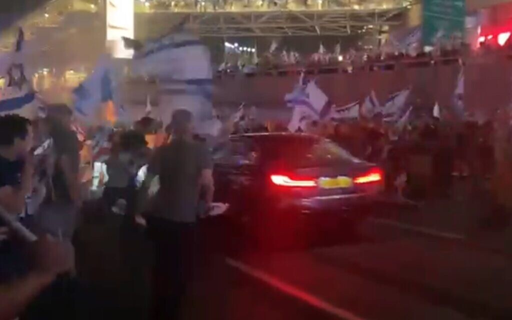 A car drives into anti-government protesters blocking the Ayalon Highway in Tel Aviv, July 5, 2023 (Video screenshot by Michel Braunstein; used in accordance with Clause 27a of the Copyright Law)