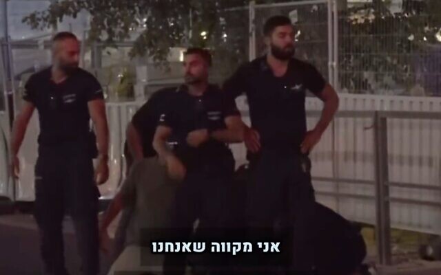 Police at an anti-overhaul protest in Tel Aviv are seen blocking Channel 13's cameraman from filming the brutal arrest of a demonstrator on July 24, 2023. (Screen capture/Twitter)