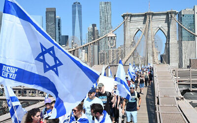 Israeli activists opposed to the judicial overhaul march across the Brooklyn Bridge in New York City, July 23, 2023. (Liri Agami)