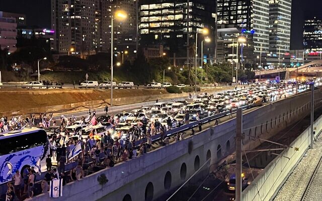 Protesters block Tel Aviv's Ayalon Highway on July 24, 2023. (Naomi Lanzkron/ Times of Israel)