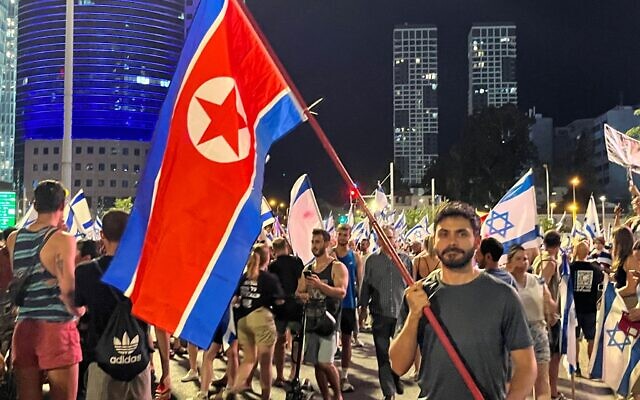 A protester with a North Korean flag demonstrates against the government in Tel Aviv, July 24, 2023. (Naomi Lanzkron)
