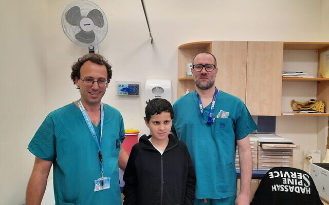 Dr. Ohad Einav and Ziv Asa with 12-year-old Suleiman Hassan at Hadassah Medical Center following his recovery after surgery to reattach his head to his neck after he suffered internal decapitation in an accident. (Courtesy of Hadassah Medical Center)