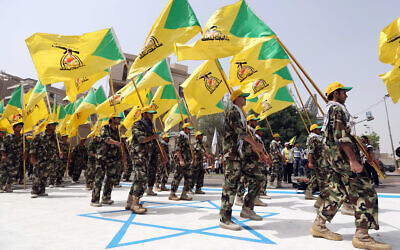 File: Members of Iraqi Kataeb Hezbollah marching in military uniforms step on a representation of an Israeli flag in Baghdad, Iraq, July 25, 2014 during the annual 'Jerusalem Day' march. (AP/Hadi Mizban)