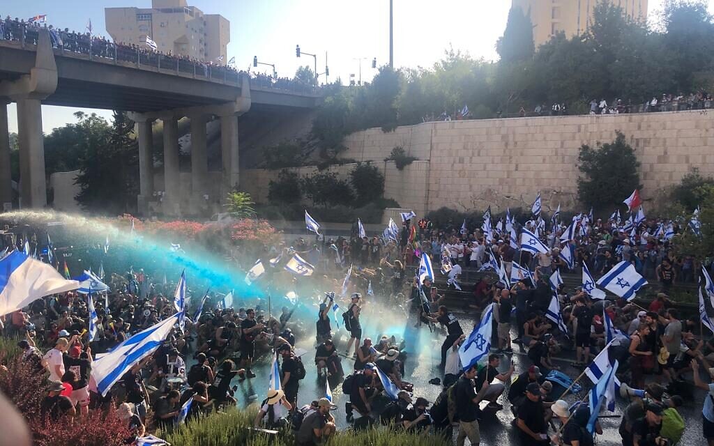 Police fire water cannons at anti-overhaul protesters on Jerusalem's Begin Highway, July 24, 2023 (Times of Israel)