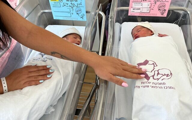 Maayan Luzon Peretz with her newborns at Shaare Zedek, on a day that saw the hospital deliver 7 sets of twins. (Courtesy)
