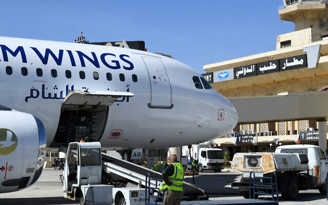 File: Employees unload an aircraft after it landed at the Aleppo airport, northern Syria, March 11, 2023. (AFP)