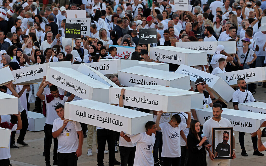 Activists march with symbolic coffins denouncing violent crime in Arab communities on August 6, 2023 in Tel Aviv. (Jack Guez/AFP)