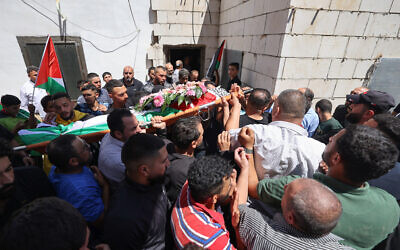 Mourners carry the body of 19-year-old Palestinian Qusai Jamal Matan, during his funeral in the town of Burqa in the West Bank on August 5, 2023. (Jaafar Ashtiyeh/AFP)