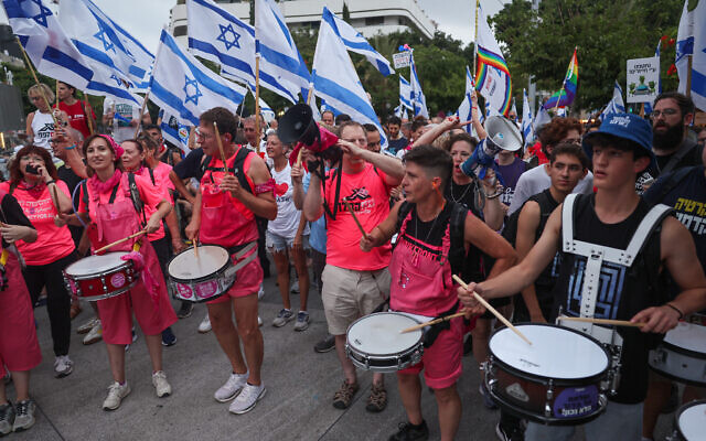 Protesters play the drums during a rally against the government's judicial overhaul plans in Tel Aviv on August 12, 2023. (JACK GUEZ/AFP)