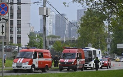 Police and emergency vehicles parked at the side of the wreckage of the drone fell near the Karamyshevskaya embankment to the after a reported drone attack in Moscow, Russia, on Friday, August 11, 2023. (AP Photo)
