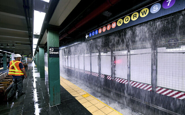 This photo, provided by MTA New York City Transit, shows water from a water main break cascading into New York's Times Square subway station, Tuesday, August 29, 2023. (Marc A. Hermann/MTA, via AP)