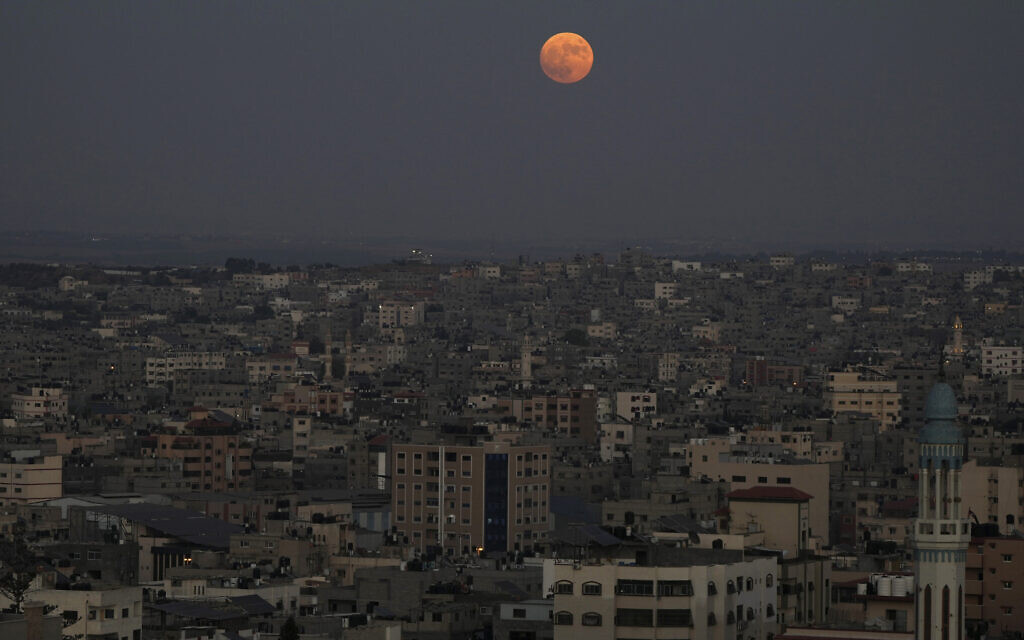 The supermoon rises in the sky over the houses of Gaza City, the Gaza Strip, August 30, 2023. (Adel Hana/AP)