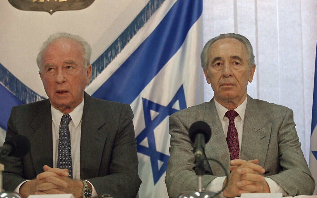 Prime Minister Yitzhak Rabin, left, and Foreign Minister Shimon Peres at the signing ceremony recognizing the PLO, September 10, 1993 at the Prime Minister's Office in Jerusalem. (AP Photo/Jerome Delay)
