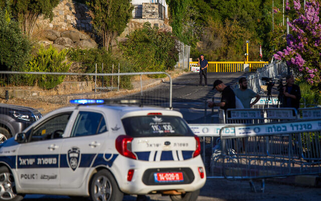 Workers and police prepare for the arrival of Prime Minister Benjamin Netanyhu and his wife Sara in Moshav Neve Ativ, August 7, 2023. (Ayal Margolin/Flash90)