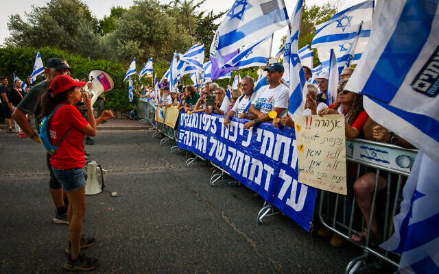 Israelis protest against the visit of Prime Minister Benjamin Netanyahu and his wife Sara, in Moshav Neve Ativ, northern Israel, August 8, 2023. (Ayal Margolin/Flash90)