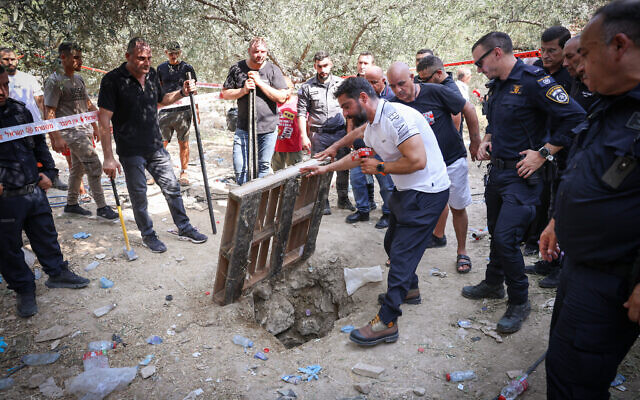 Police and rescue personnel at the scene where two firefighters and another man fell into a hole in the ground in Deir el-Asad In August 13, 2023. (David Cohen/Flash90) Police and rescue personnel at the scene where two firefighters and another man fell into a hole in the ground in Deir el-Asad In August 13, 2023. (David Cohen/Flash90)