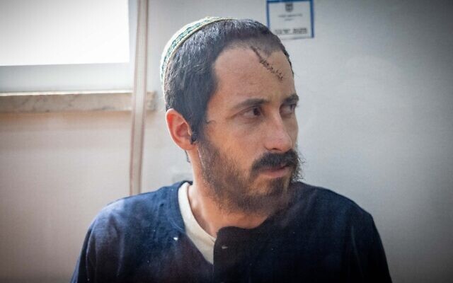 Yehiel Indore, who is suspected of shooting and killing 19-year-old Palestinian Qusai Jamal Matan in the West Bank village of Burqa, arrives for a Jerusalem District Court hearing on August 14, 2023. (Chaim Goldberg/Flash90)