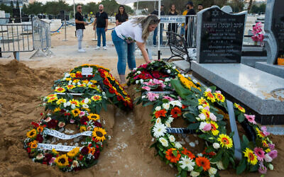 The graves of Shay Silas Nigreker and his son Aviad Nir, following their funeral in Ashdod on August 20, 2023. (Flash90)